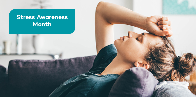 Caucasian woman laying on couch with hand on forehead